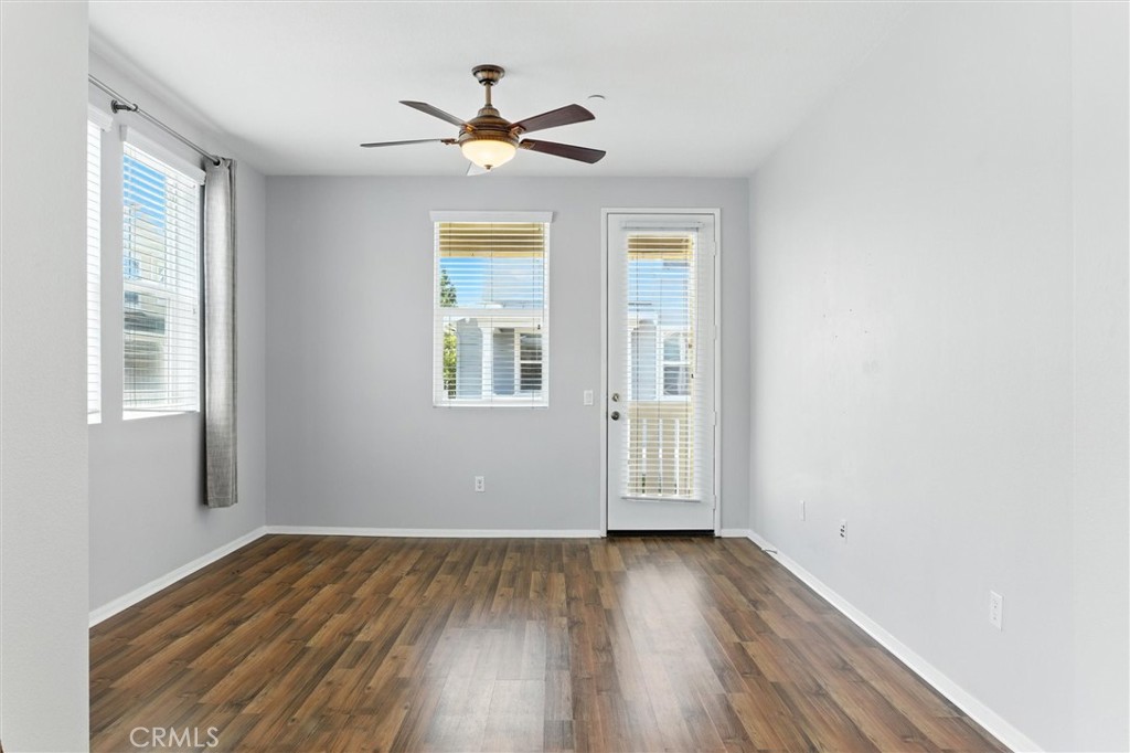57 Hinterland Way Ladera Ranch, CA 92694 - Photo 6 of 41 an empty room with wooden floor chandelier fan and windows