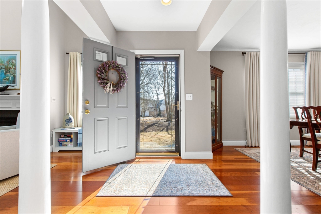 31 Stratford Ridge, Unit 31 Mashpee, MA 02649 - Photo 3 of 41 a view of a hallway with wooden floor and a living room