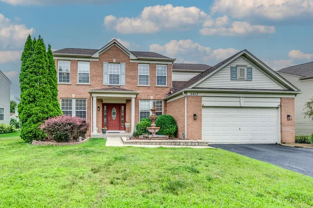 a front view of a house with a yard and garage