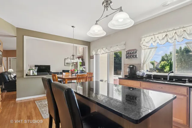 a kitchen with stainless steel appliances granite countertop sink stove top oven and cabinets