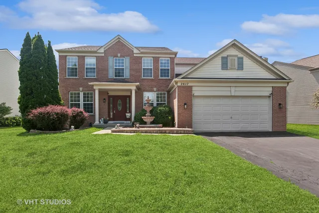a front view of a house with a yard and garage