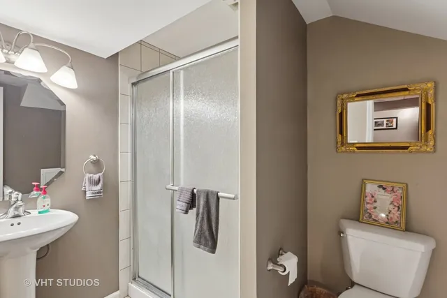 a bathroom with a toilet sink and shower