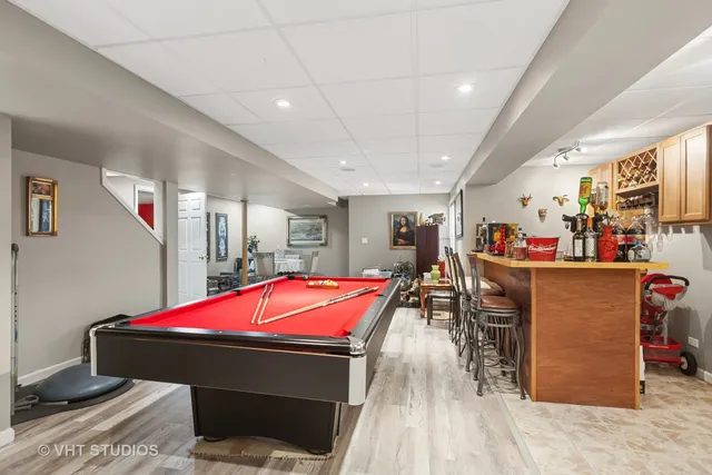 a living room with furniture a wooden floor and potted plants