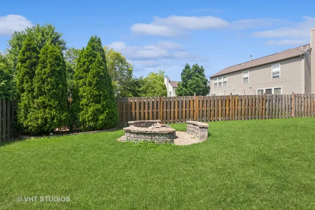 a view of a chair and table on the green field