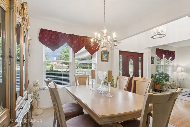a view of a dining room with furniture wooden floor and chandelier