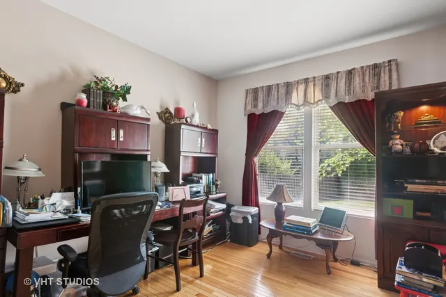 a living room with furniture a flat screen tv and a large window