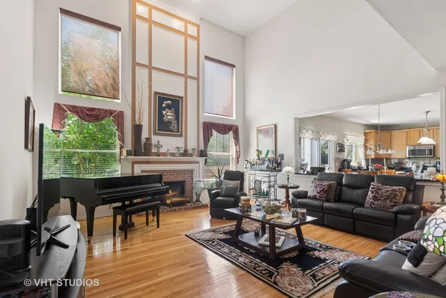 a living room with furniture fireplace and a large window