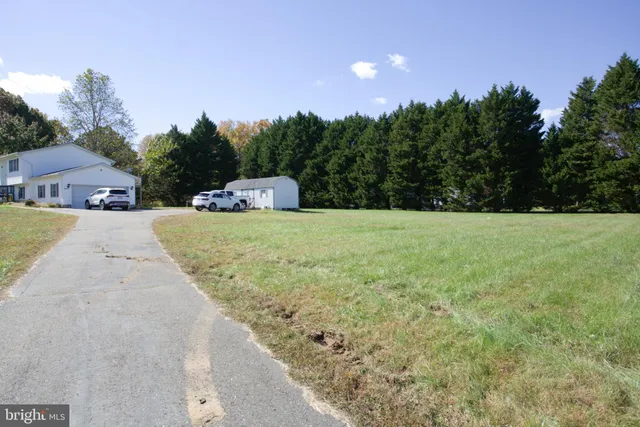 a view of a yard with a house in the background