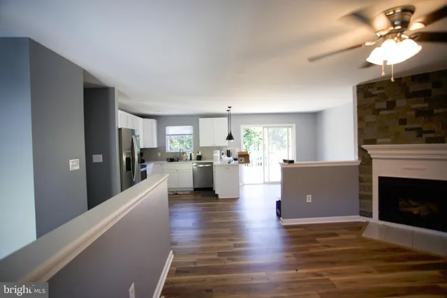 a living room with furniture a fireplace and a chandelier