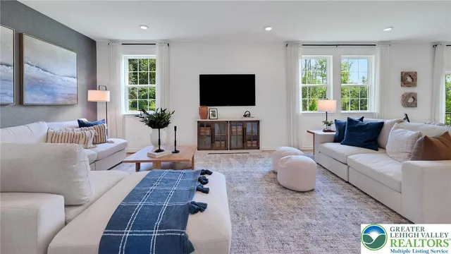 a very nice looking living room with a large window and a clock