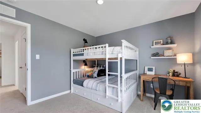 a bedroom with a bed next to a window