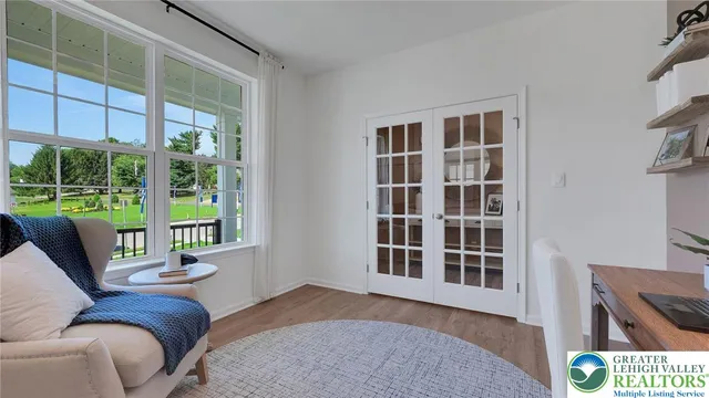 a living room with furniture and a floor to ceiling window