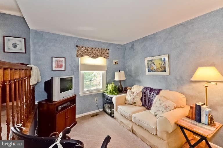 2959 Gracefield Road Silver Spring, MD 20904 - Photo 22 of 28 a living room with furniture flat screen tv and a lamp