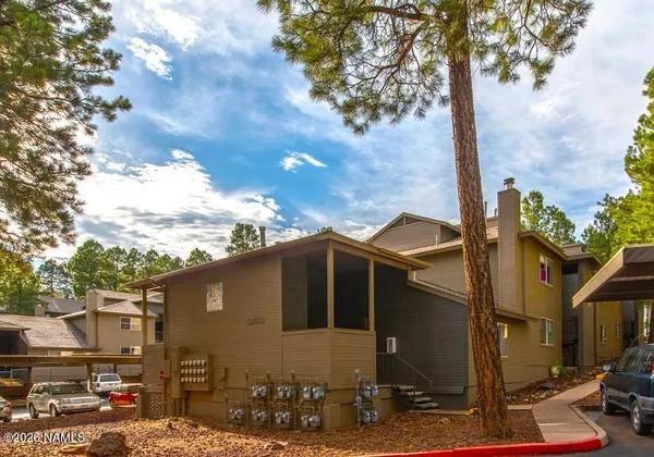 a front view of a house with parking space