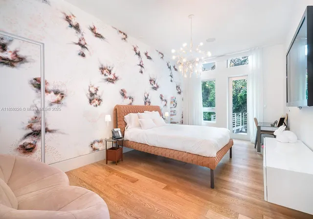 a spacious bedroom with a bed couch and a window