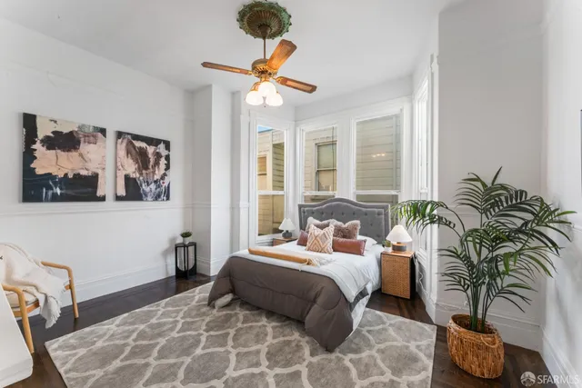 a bedroom with a large bed and a chandelier