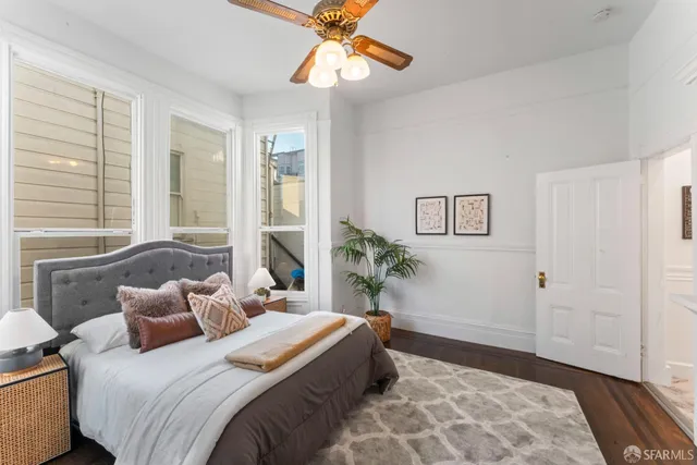 a bedroom with a large bed and a chandelier