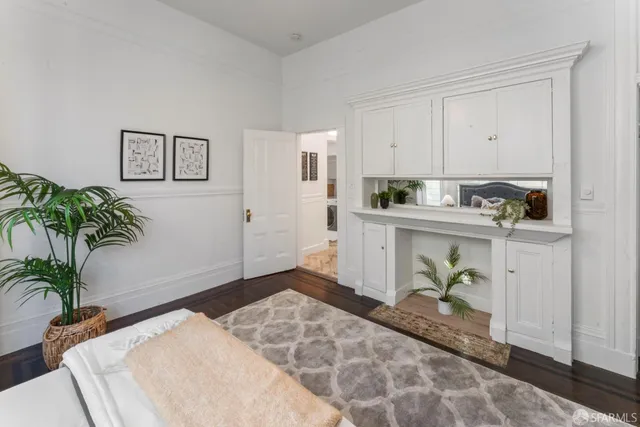 a bedroom with furniture and a potted plant