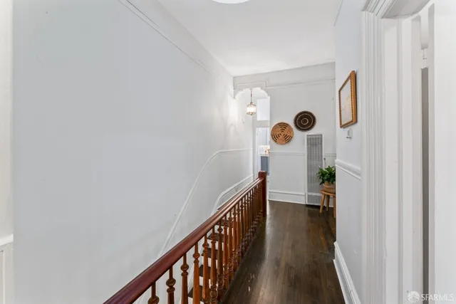 a view of hallway with wooden floor