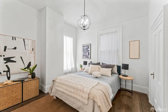 a bedroom with a bed and a chandelier