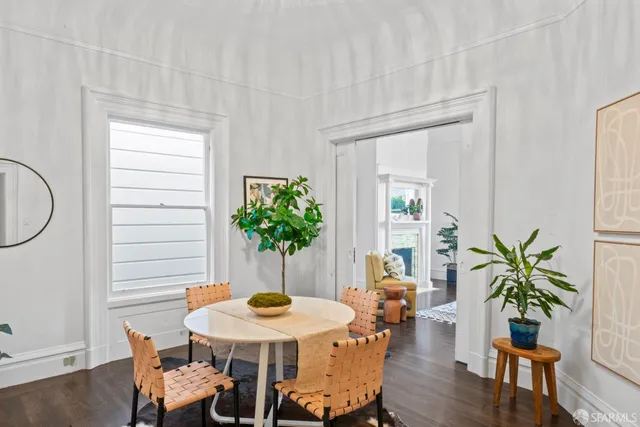 a view of a dining room with furniture and wooden floor