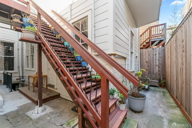 a backyard of a house with outdoor seating and stairs