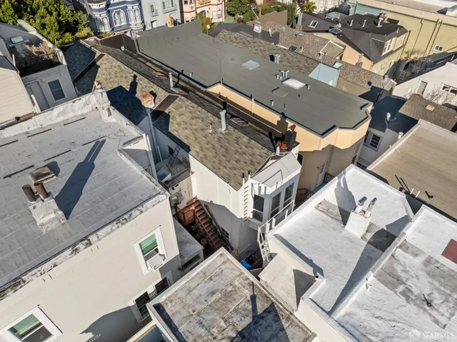 an aerial view of a house with a patio
