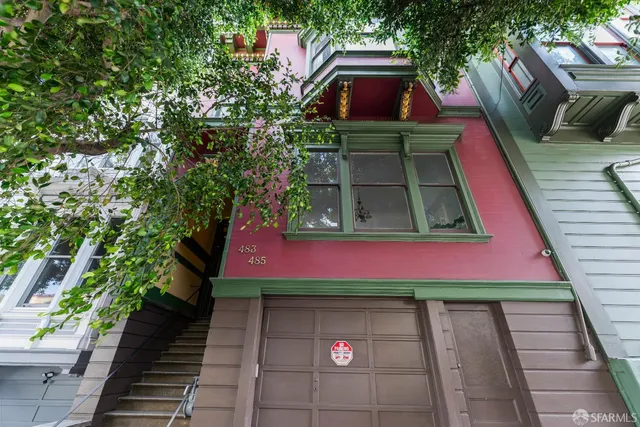 a view of a house with a door and a yard