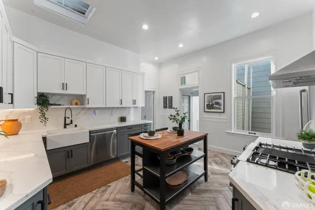 a kitchen with a sink stove and cabinets