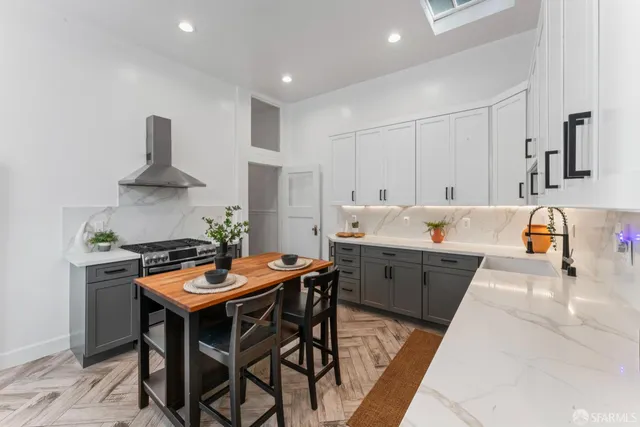 a kitchen with stainless steel appliances a sink and a stove