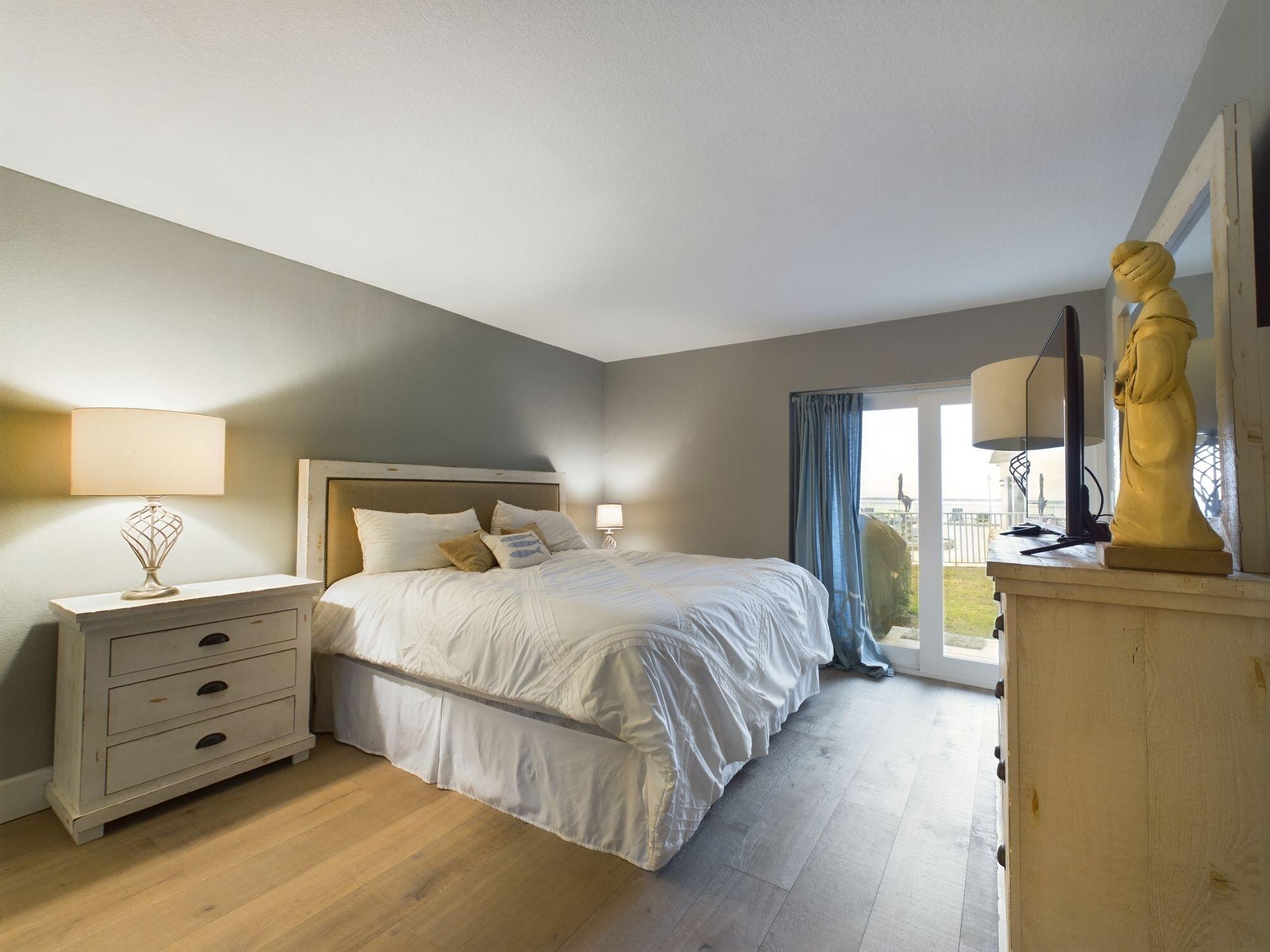 151 Calhoun Avenue, Unit 108 Destin, FL 32541 - Photo 12 of 30 a bedroom with a bed and wooden floor