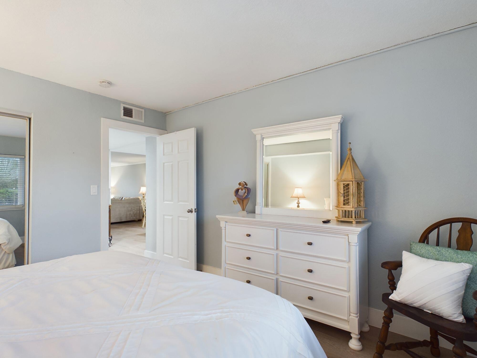 151 Calhoun Avenue, Unit 108 Destin, FL 32541 - Photo 17 of 30 a bedroom with a bed and a dresser