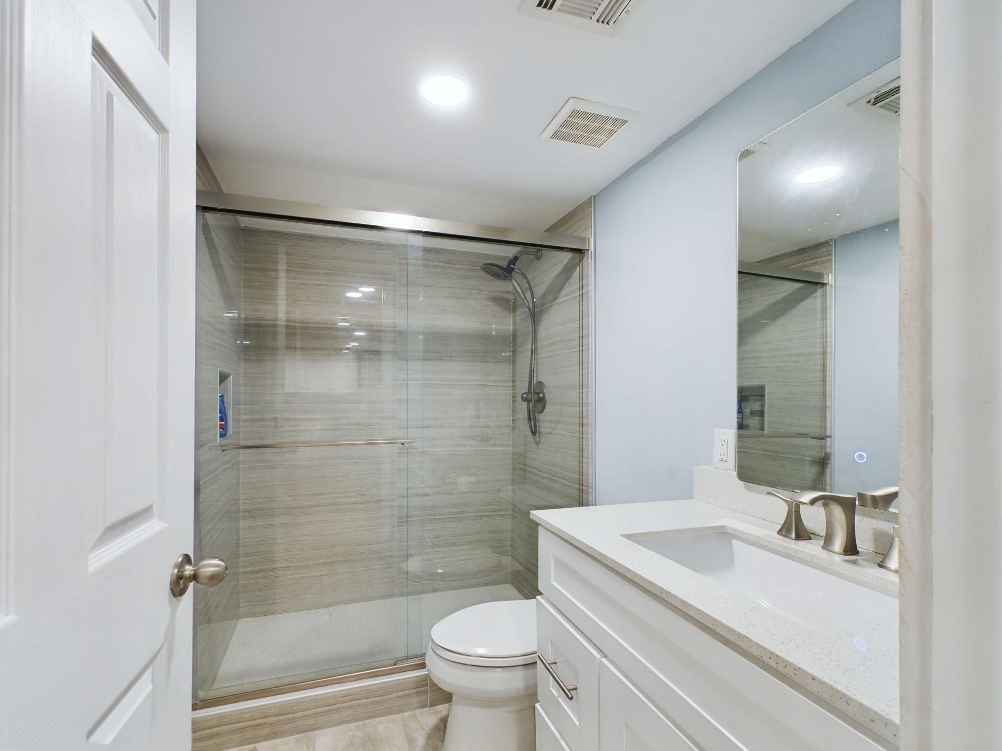 151 Calhoun Avenue, Unit 108 Destin, FL 32541 - Photo 18 of 30 a bathroom with a sink a toilet and shower