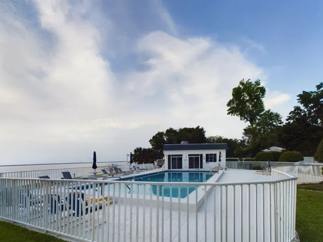 a view of a house with entryway and a wooden door