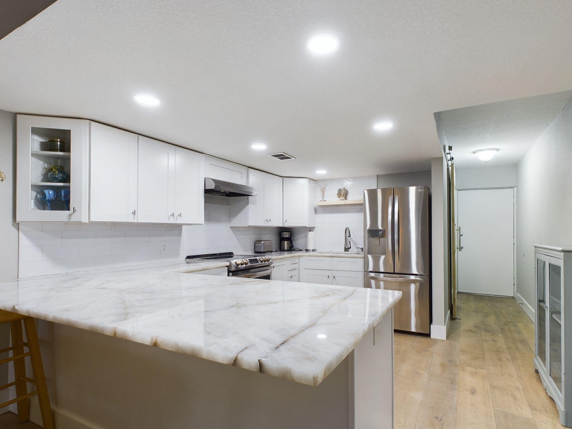 151 Calhoun Avenue, Unit 108 Destin, FL 32541 - Photo 28 of 30 a kitchen with stainless steel appliances granite countertop a sink refrigerator and cabinets