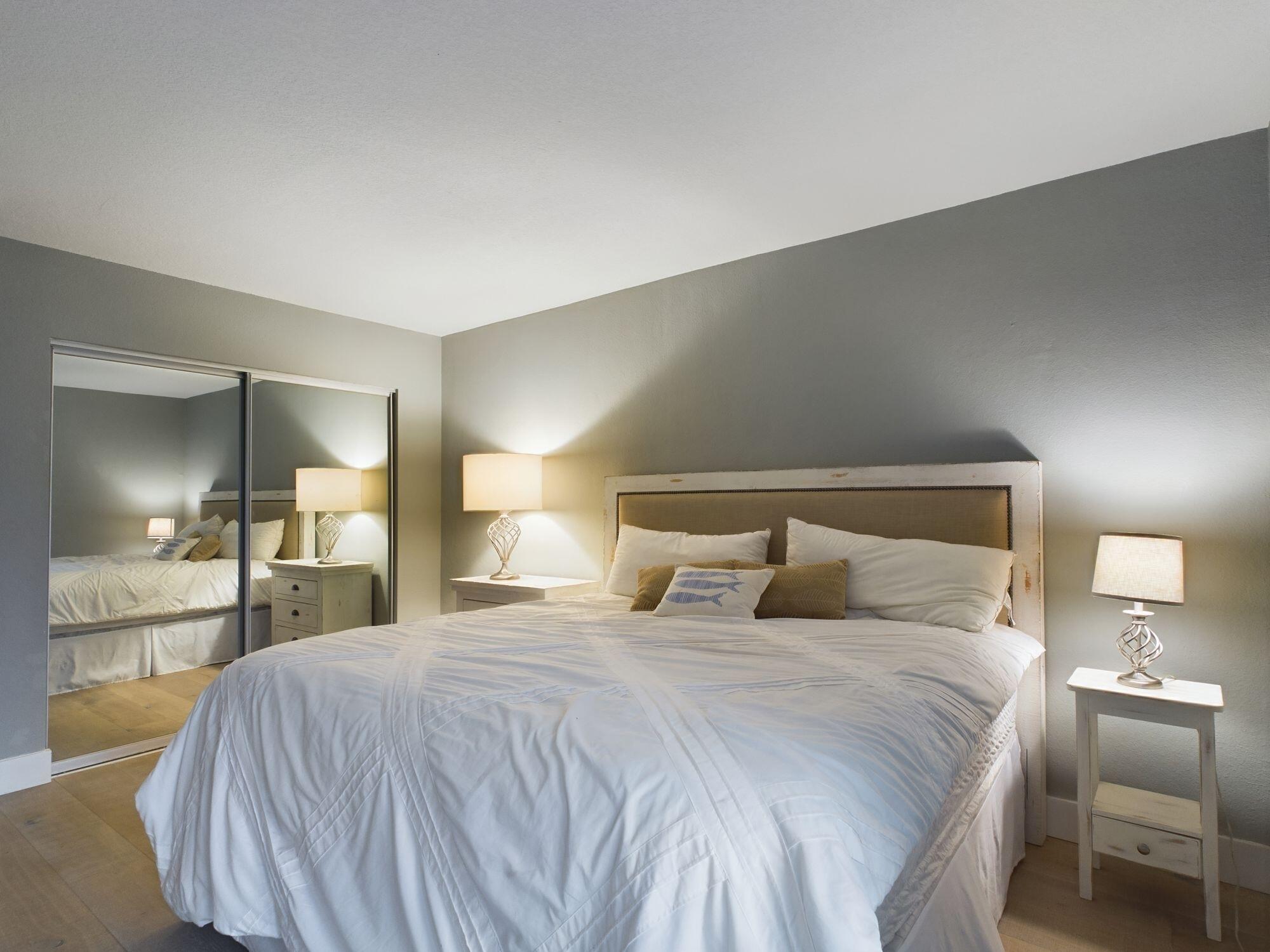 151 Calhoun Avenue, Unit 108 Destin, FL 32541 - Photo 30 of 30 a bedroom with a bed and a large mirror