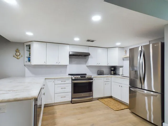 a kitchen with a stove sink and refrigerator