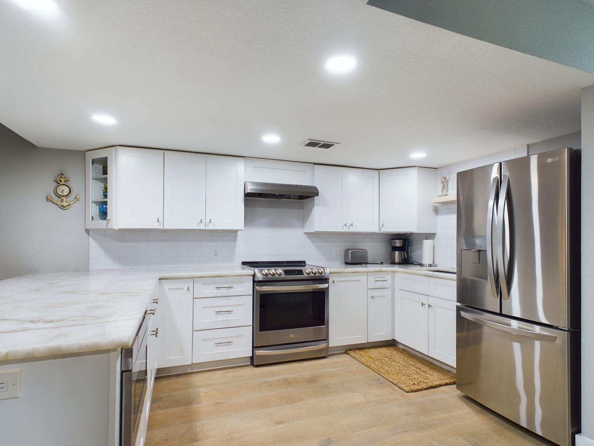 151 Calhoun Avenue, Unit 108 Destin, FL 32541 - Photo 4 of 30 a kitchen with a stove sink and refrigerator