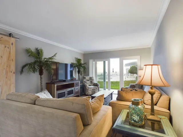 a living room with furniture fireplace and a large window