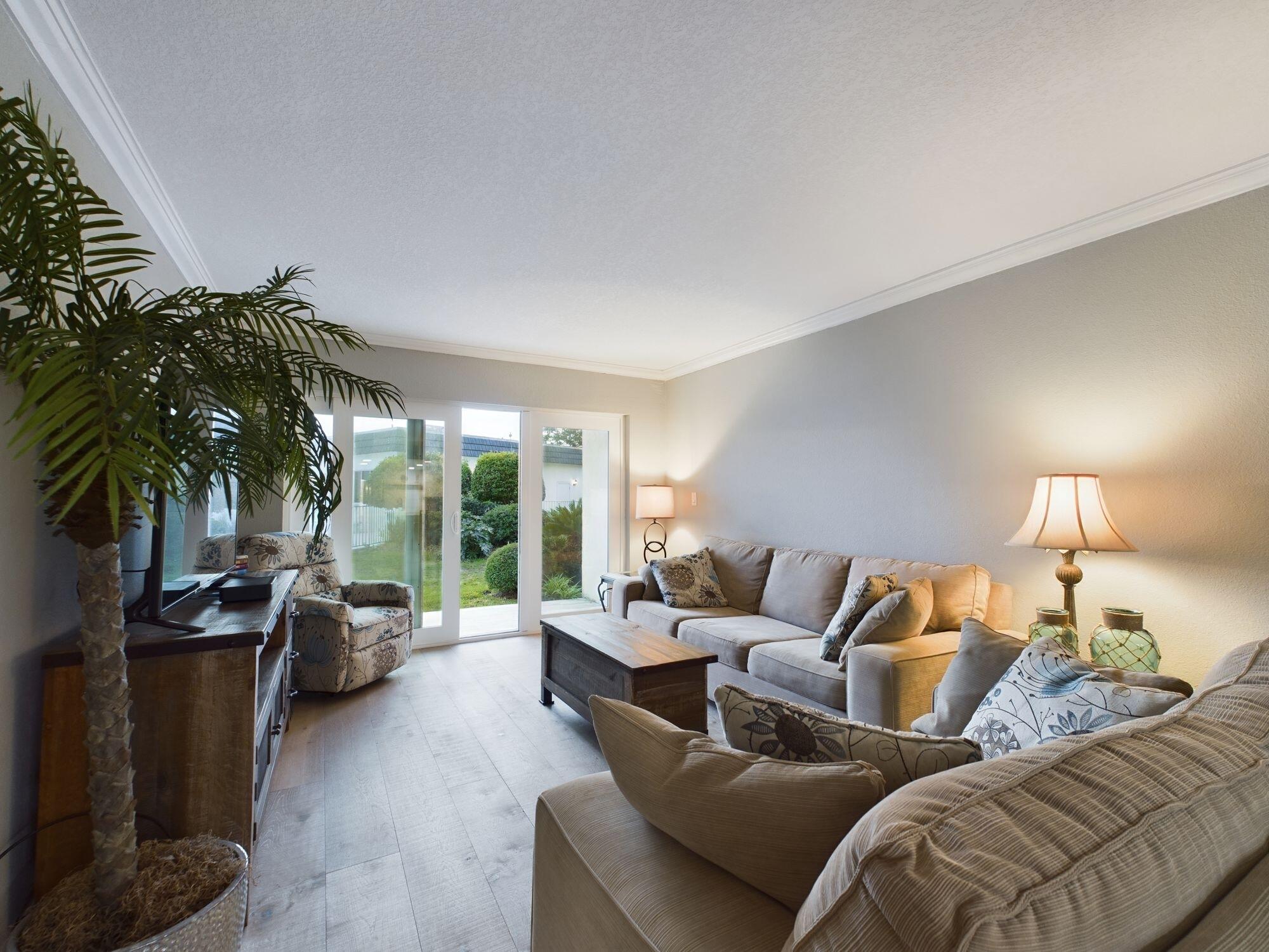 151 Calhoun Avenue, Unit 108 Destin, FL 32541 - Photo 8 of 30 a living room with furniture and a potted plant