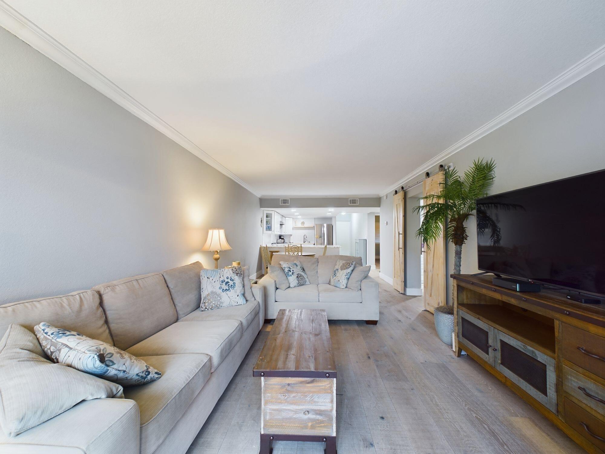 151 Calhoun Avenue, Unit 108 Destin, FL 32541 - Photo 10 of 30 a living room with furniture and a flat screen tv