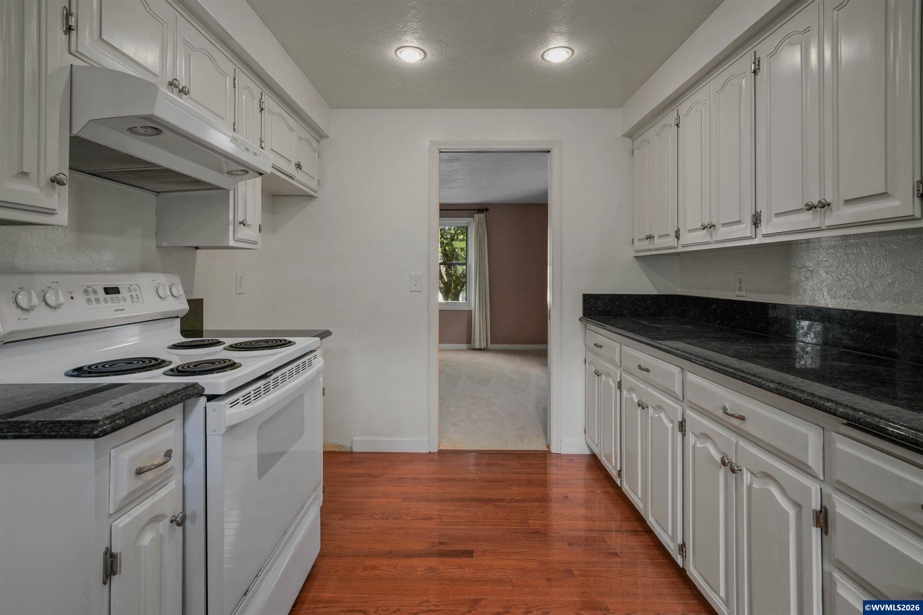 220 Northwest Downy Drive Sublimity, OR 97385 - Photo 10 of 47 a kitchen with granite countertop a stove and a sink