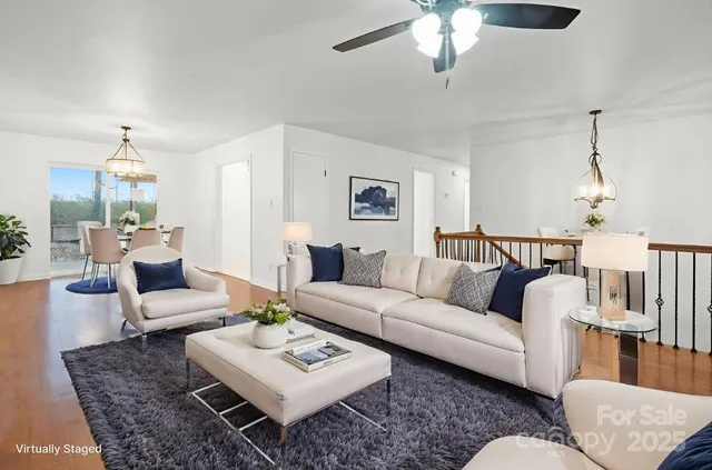 a living room with furniture and a chandelier