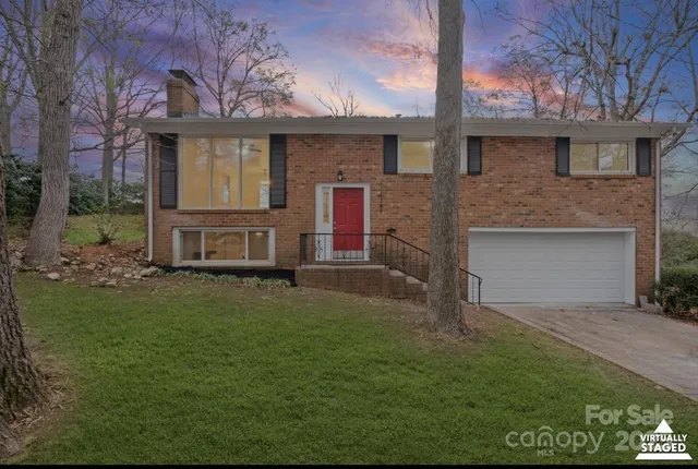 a front view of a house with a garden and plants