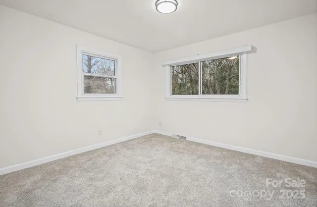 a bedroom with a large bed and a potted plant