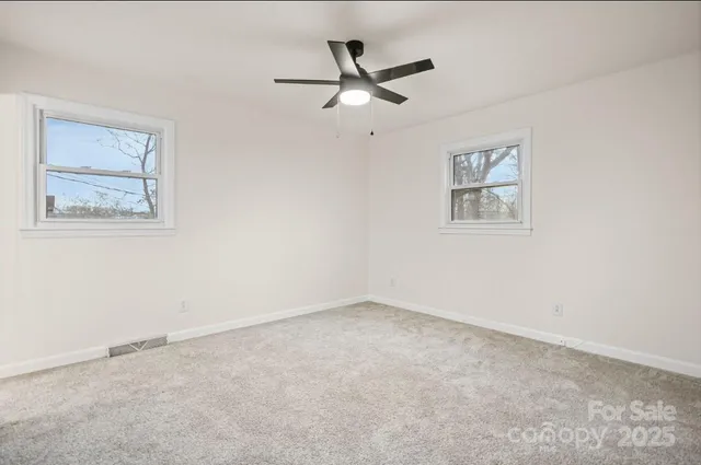 a bedroom with a large bed and a painting on the wall