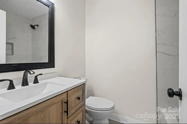a view of a patio with table and chairs and wooden fence