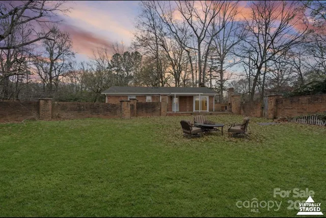 a backyard of a house with table and chairs