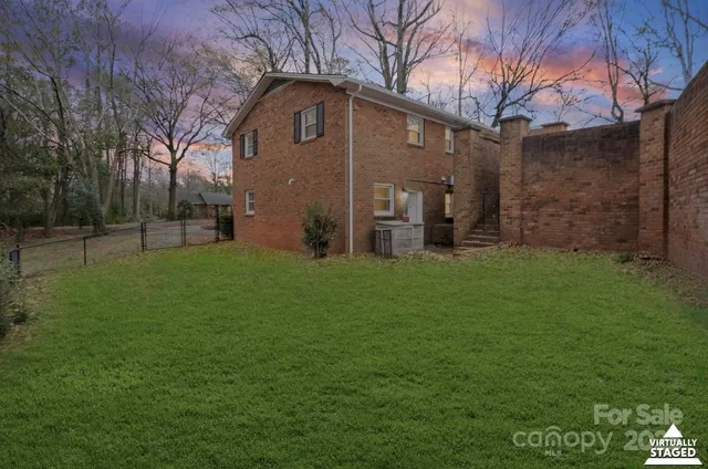 a view of a house with a backyard and sitting area