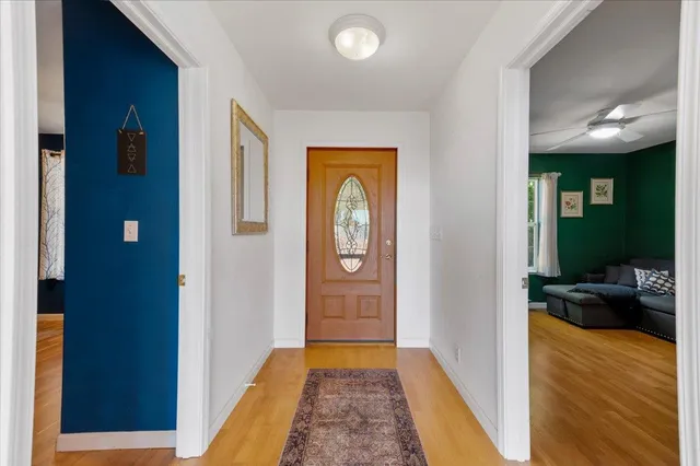 a bedroom with a bed and a painting on the wall